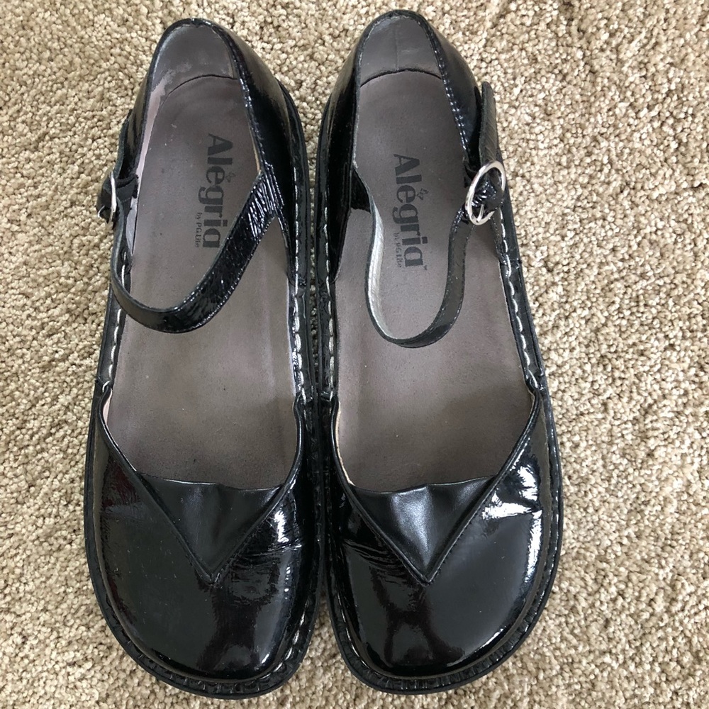Black Alegria ankle buckled shoes.